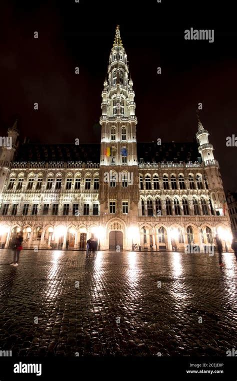 Panoramic night view of grand place of Brussels ( Belgium ) during rain. Long time exposure. The ...