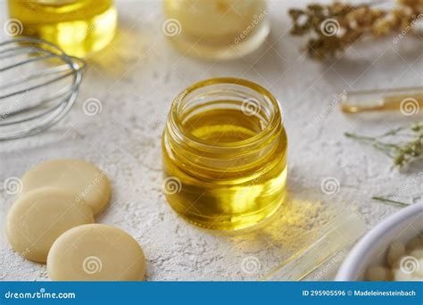 Essential Oil With Cocoa Butter And Beeswax Pellets Ingredients For Homemade Cosmetics Stock