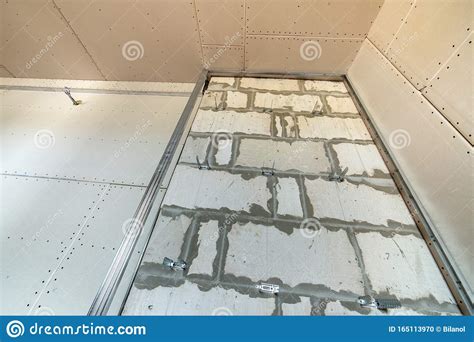 Unfinished Brick Wall In A Room Under Construction Prepared For Drywall