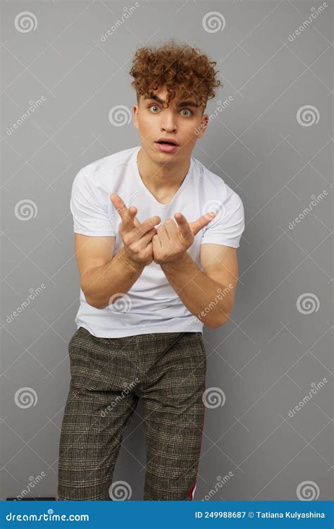 A Very Surprised Shocked Man Stands On A Gray Background In A Cotton