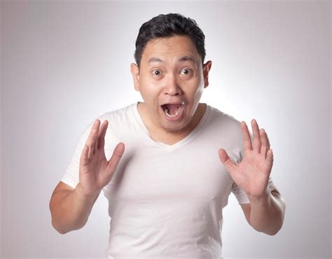 Premium Photo Asian Men Shows Winning Gesture Shocked Surprised With