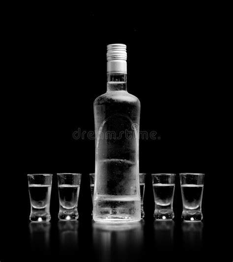 Bottle And Glasses Of Vodka Standing Isolated On Black Background Stock Image Image Of Liquor