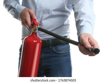 Worker Using Fire Extinguisher On White Stock Photo