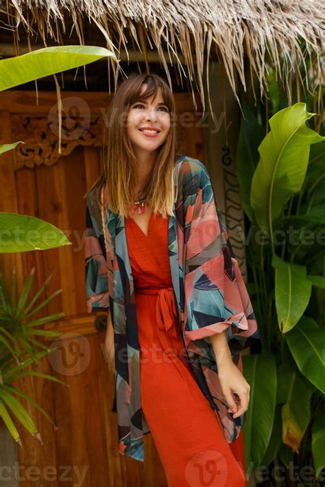 Smiling carefree brunette woman in stylish summer outfit enjoing ...