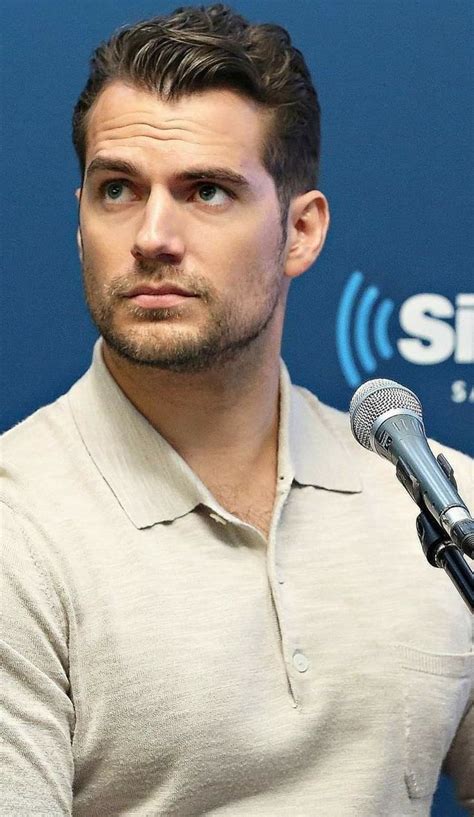 A Man Sitting In Front Of A Microphone With His Eyes Closed And Looking