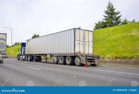 Big Rig Blue Semi Truck With Loaded Container On Semi Trailer Standing