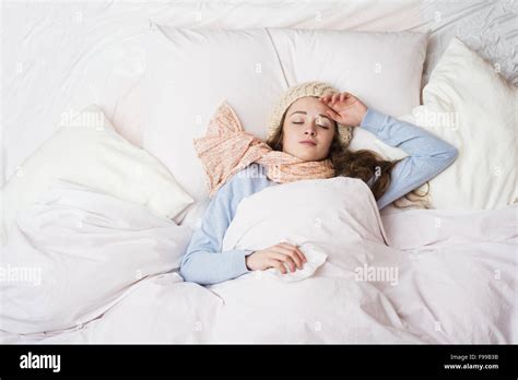 Sick Woman Lying In Bed With High Fever She Has Cold And Flu Stock