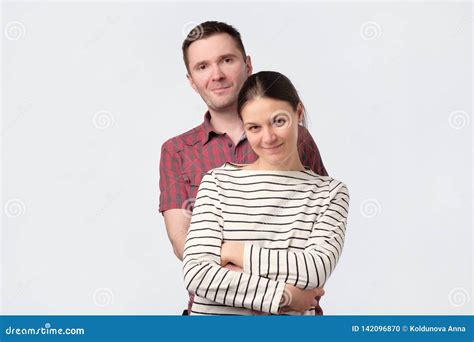 Young European Couple Standing Against White Gray Background Stock