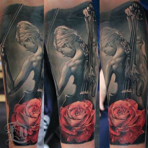 A Woman With A Violin And Rose Tattoo On Her Leg