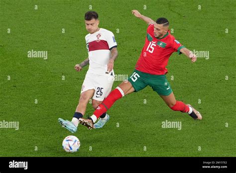 Doha, Qatar. 10th Dec, 2022. Selim Amallah (R) of Morocco vies with Otavio of Portugal during ...