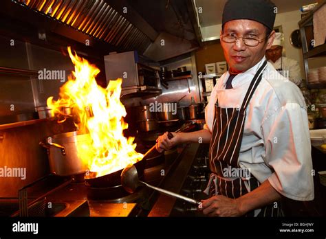 Asian chef cooking in Restaurant kitchen Stock Photo - Alamy