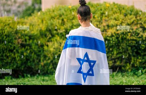 Teenager patriot jewish girl standing with the flag of Israel wrapped ...