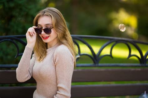 Beautiful Woman Walks Through City Streets Between Building Stock Image