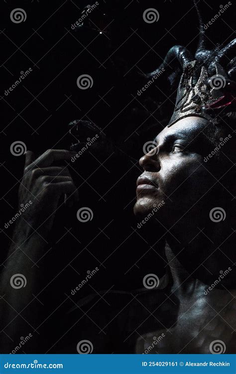 Portrait Of A Man In The Image Of A Basilisk With Body Art With A Naked Torso And A Headdress In