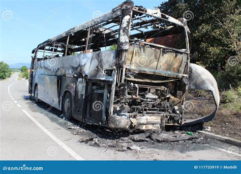 Burnt Bus Is Seen On The Road After Caught In Fire During Travel Stock