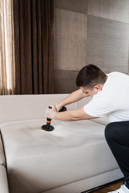 Premium Photo Smearing Detergent On Couch Using Drill With Brush For