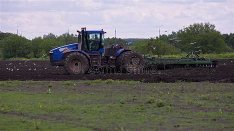 Blue Tractor With Double Wheels Pulling Disc Harrow With Roller Basket