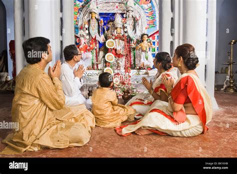 Family praying in a temple Stock Photo - Alamy