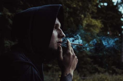 Premium Photo Side View Of Man Smoking Cigarette Outdoors