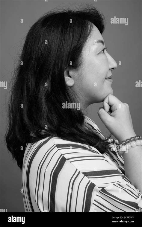 Mature Beautiful Asian Businesswoman Against Gray Background Stock Photo Alamy