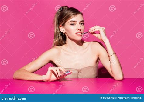 Young Woman Applies Pink Lipstick On Lips Close Up Beauty Portrait Of