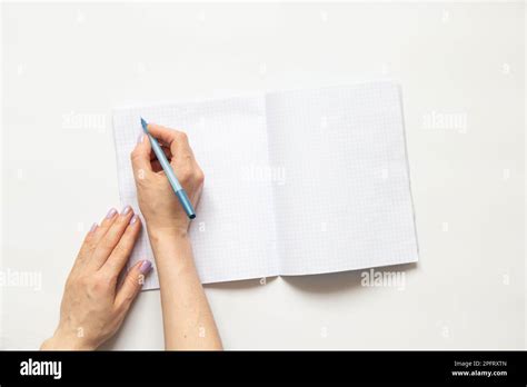 Female Hands Write In A Notebook In A Cage On A White Background Blank