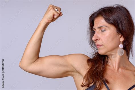 Strong Fit Mature Woman Flexing Her Arm Muscles Stock Photo Adobe Stock