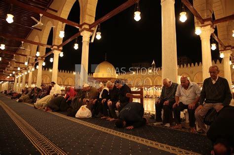 Worshipers praying in a mosque, performing the obligatory prayer in the ...