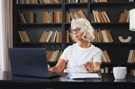 Confident Stylish Middle Aged Senior Woman Using Laptop At Workplace Older Mature Lady