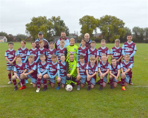 Burnham United Junior Football Club Team Unveils New Kits Thanks To