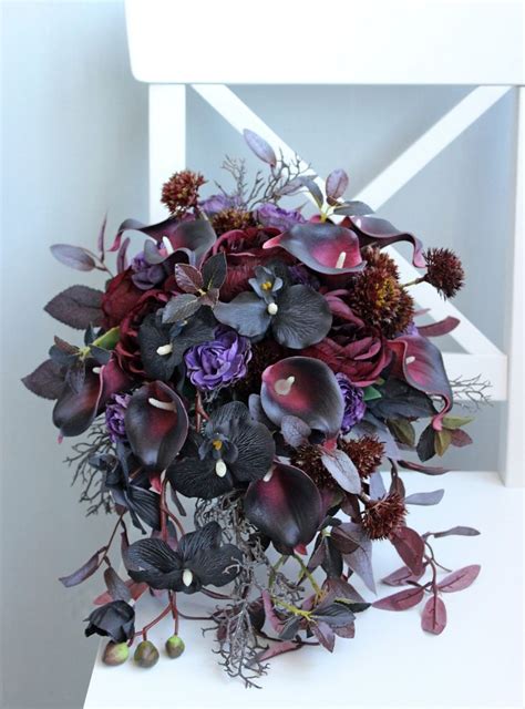 A Bouquet Of Flowers Sitting On Top Of A White Table