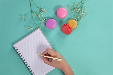 Premium Photo Woman Writing On Her Notebook On A Green Background