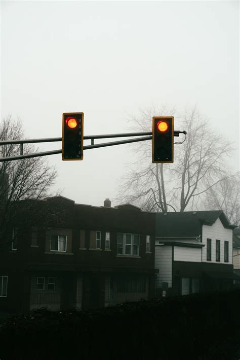 A traffic light hanging over a city street photo – Free Grey Image on ...