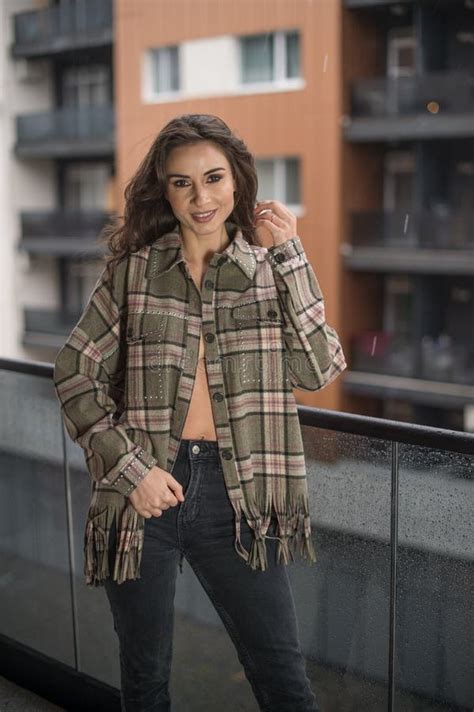 Gorgeous Glamour Brunette Woman With Plaid Jacket Posing On Modern Balcony With Amazing View On