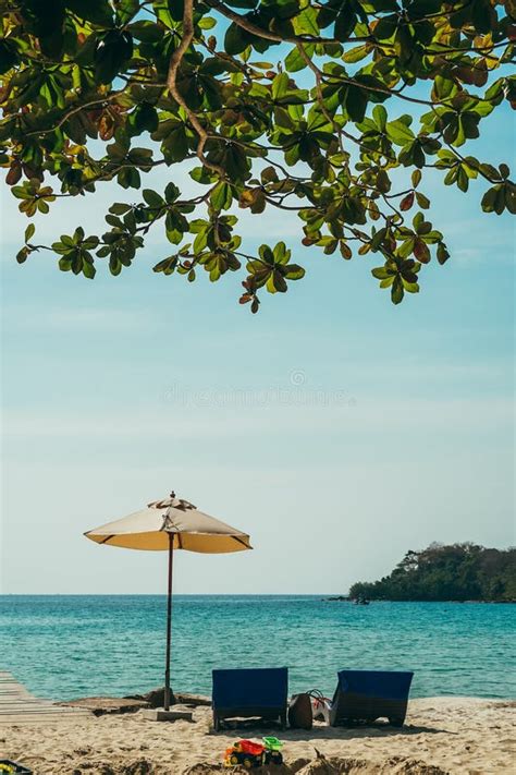 Two Empty Beach Chairs And Umbrella At A Beach In Koh Kood Thailand