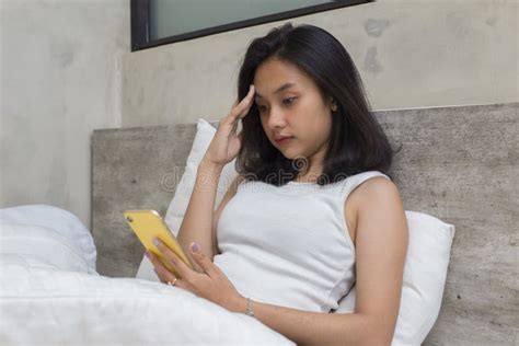 Sick Young Asian Beautiful Woman Drinking Water In Bed Stock Image