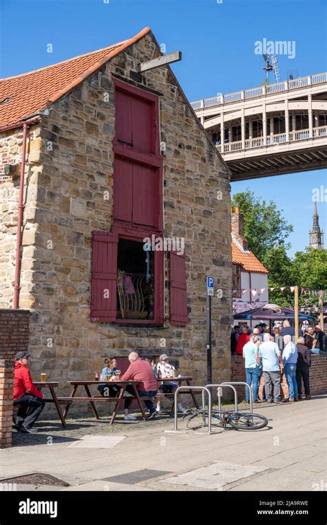 The Traditional Pub Exterior And People Drinking Outside Of The