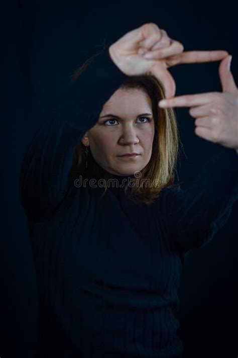 Portrait Of A Beautiful Blonde Woman Who Is Looking For An Optimal Framing With Her Fingers