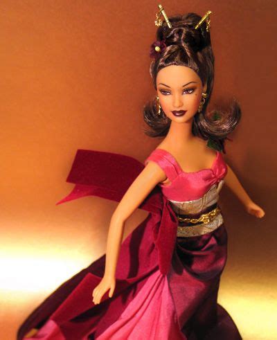 A Barbie Doll Wearing A Pink Dress And Gold Tiara With Her Hair