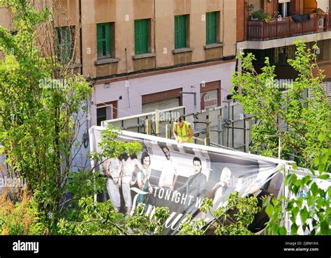 Man Placing Advertising Poster On An Advertising Billboard In Barcelona