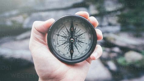 Close Up Of Hand Holding Navigational Compass Stock Photo