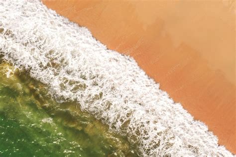 Premium Photo Aerial Image Of White Surf Splashing On A Sandy Beach