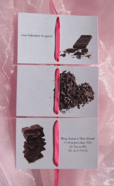 Three Pieces Of Chocolate Sitting On Top Of A Pink Cloth Covered Table