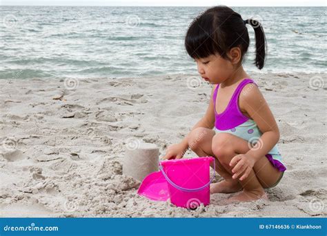 Asian Little Chinese Girl Playing Sand With Beach Toys Stock Photo