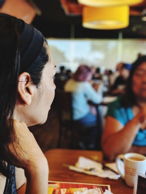 Premium Photo Close Up Of Woman Sitting At Table In Restaurant