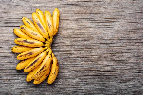 Bananas On An Old Wooden Tablea Bunch Of Ripe Bananas Ripe Unpeeled