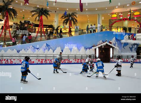 Kids playing ice hockey on the ice rink in the Al Ain Mall, Al Ain, Abu Dhabi, United Arab ...