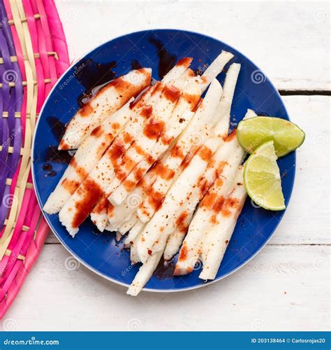 Mexican Jicama Cutted With Chili Powder And Piquant Sauce On White