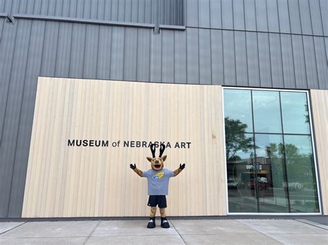 Museum of Nebraska Art - A cowboy sits on his horse looking at a cow