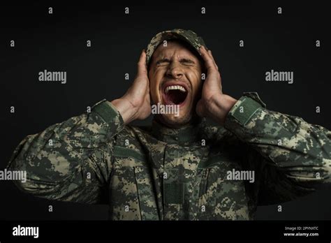 Stressed Soldier In Camouflage Uniform And Cap Screaming While